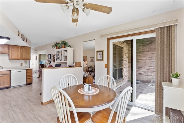 dining space with light wood-style floors and ceiling fan