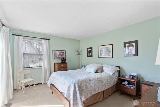 carpeted bedroom featuring baseboards and visible vents