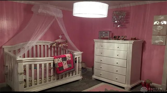 bedroom featuring a crib