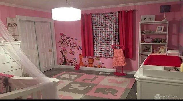 bedroom featuring baseboards, a closet, and ornamental molding