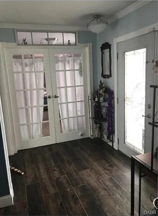 entryway with dark wood-style flooring, french doors, and ornamental molding