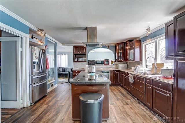 kitchen with crown molding, island range hood, dark wood-style flooring, and stainless steel appliances