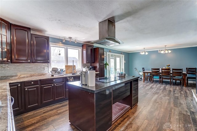 kitchen featuring island exhaust hood, ornamental molding, dark wood-type flooring, black electric stovetop, and backsplash