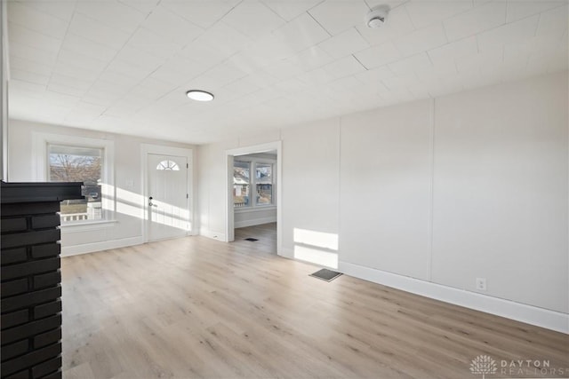 interior space with visible vents, baseboards, and wood finished floors