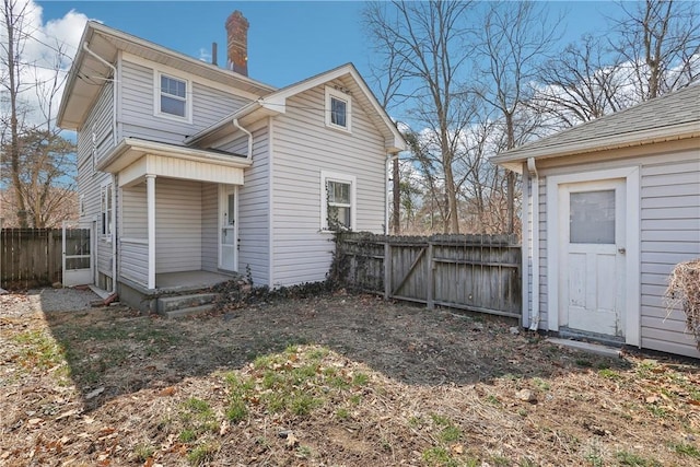 rear view of house with fence