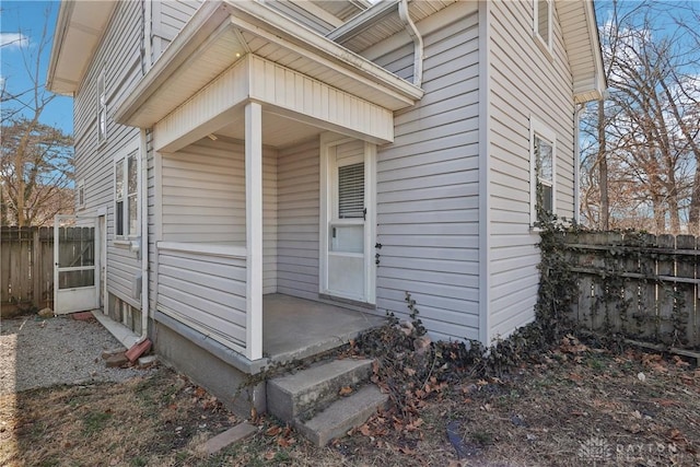 doorway to property featuring fence