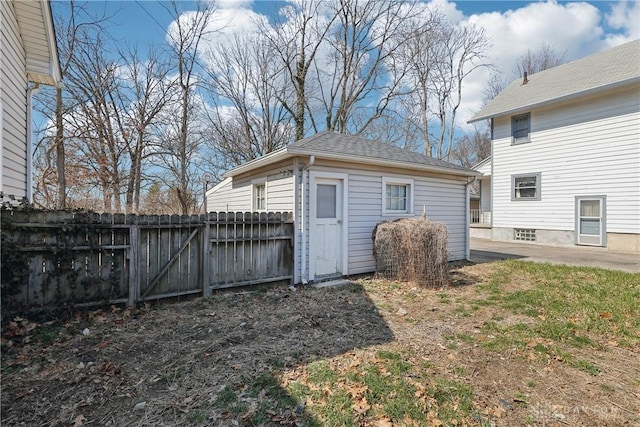 view of outbuilding with fence