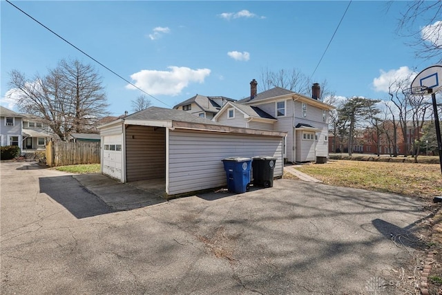 exterior space with aphalt driveway and fence