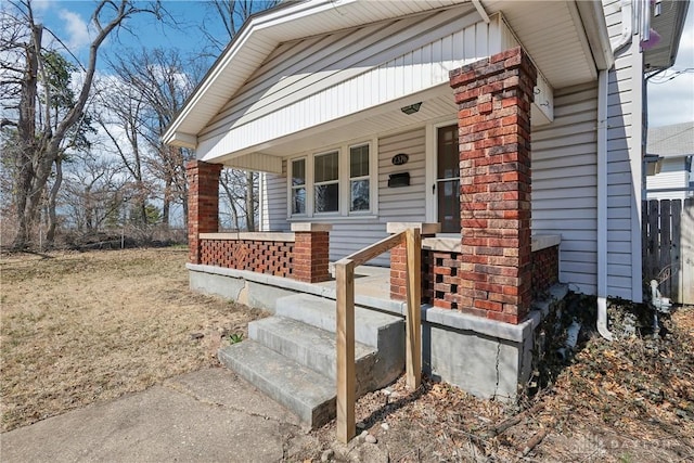 view of exterior entry featuring covered porch