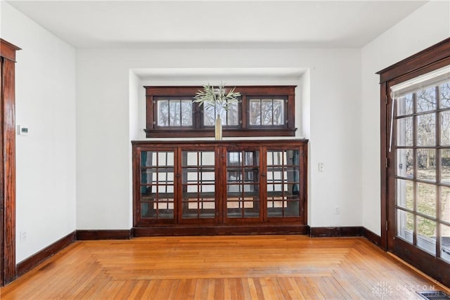 interior space with visible vents, baseboards, and a healthy amount of sunlight