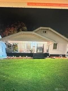 back of house with a lawn