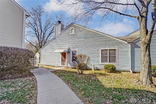 view of front of home featuring a chimney