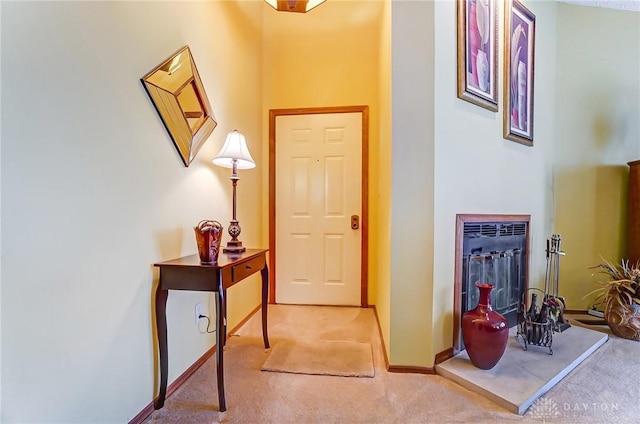 hallway featuring baseboards and carpet floors