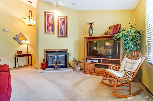 living area with a glass covered fireplace and carpet floors