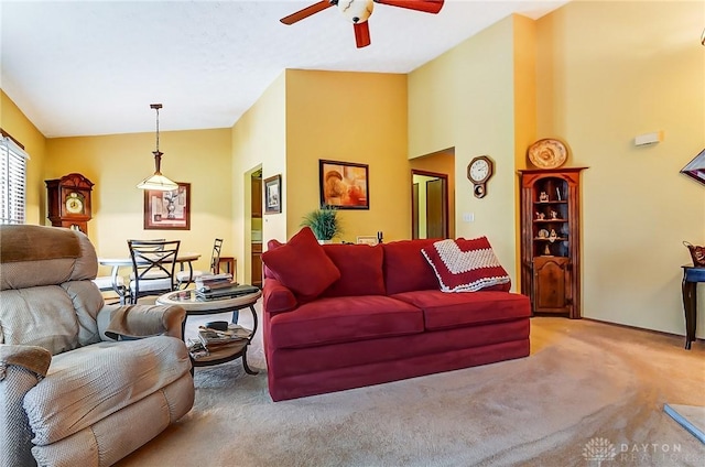 carpeted living area featuring lofted ceiling and ceiling fan