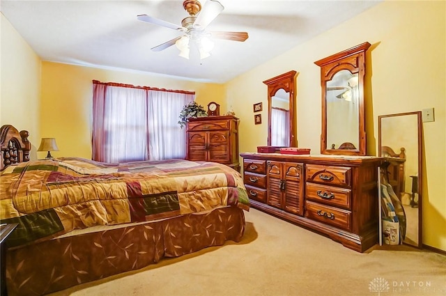 bedroom with a ceiling fan and carpet