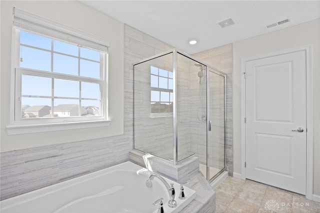 full bathroom featuring visible vents, a stall shower, and a garden tub