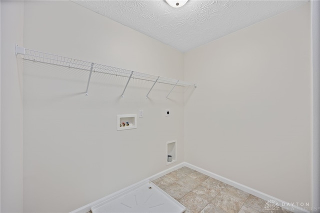 washroom featuring electric dryer hookup, washer hookup, a textured ceiling, baseboards, and laundry area