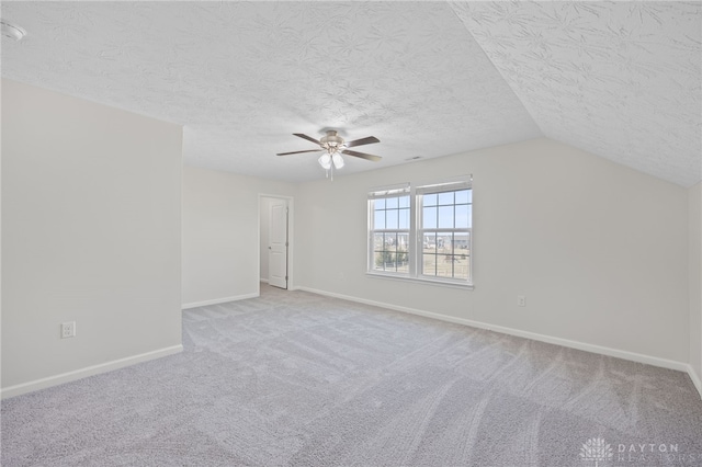 interior space with a ceiling fan, baseboards, carpet floors, and a textured ceiling