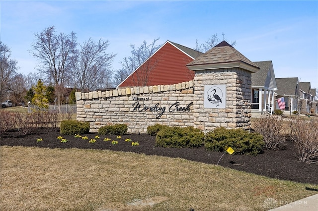 community / neighborhood sign with a yard