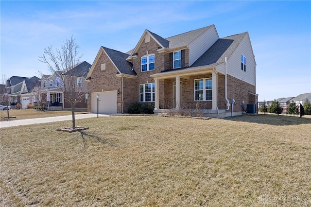 traditional-style house with a front lawn, fence, a garage, brick siding, and central AC unit