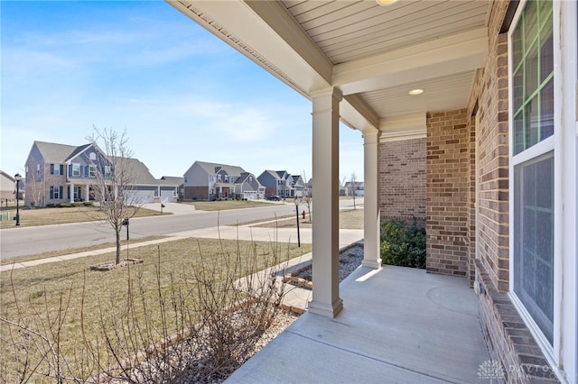 view of patio / terrace featuring a residential view and a porch