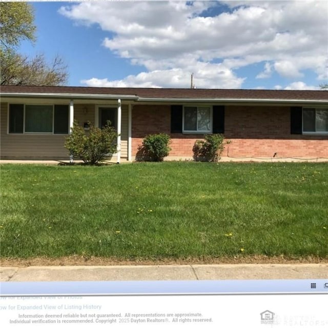 ranch-style house with brick siding and a front lawn