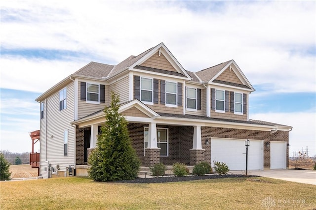 craftsman-style home with brick siding, driveway, an attached garage, and a front lawn