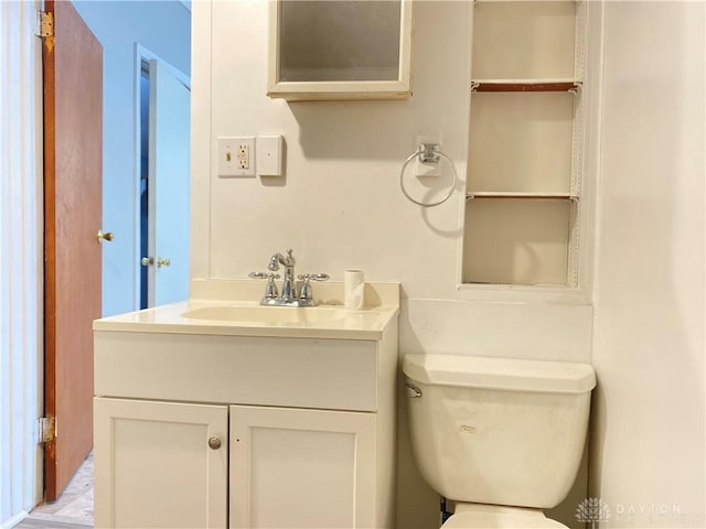 bathroom featuring toilet and vanity