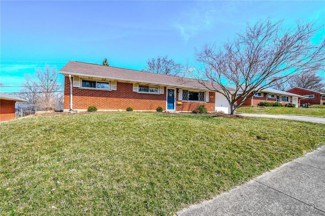 single story home with a front lawn, a garage, and brick siding