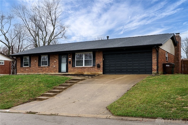 single story home with a front yard, driveway, an attached garage, a chimney, and brick siding