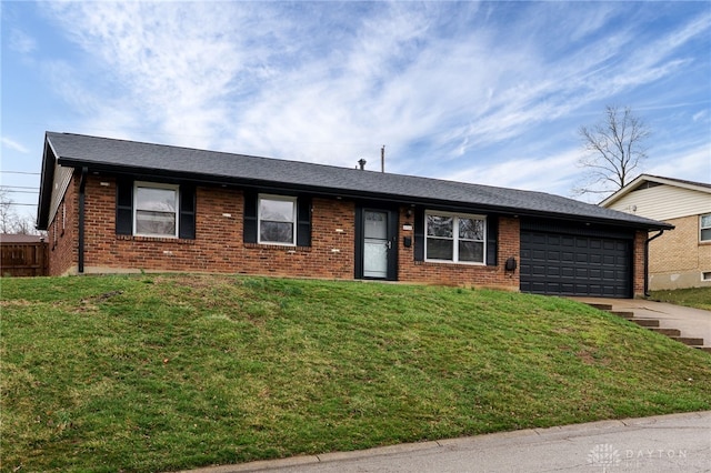 ranch-style house featuring brick siding, driveway, a front yard, and an attached garage