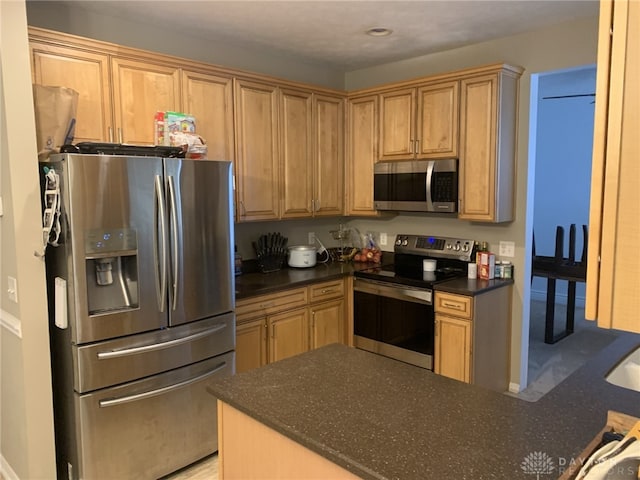 kitchen featuring dark countertops and appliances with stainless steel finishes