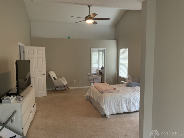 bedroom featuring baseboards, light carpet, high vaulted ceiling, and a ceiling fan