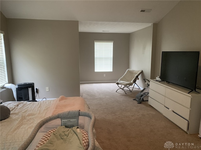 bedroom with visible vents and light carpet