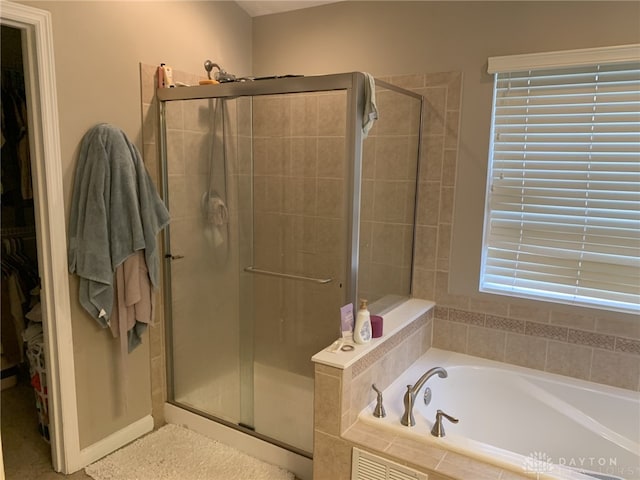 bathroom featuring a bath, visible vents, and a stall shower