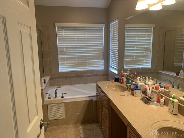 bathroom with visible vents, tiled shower, a sink, tile patterned floors, and a bath