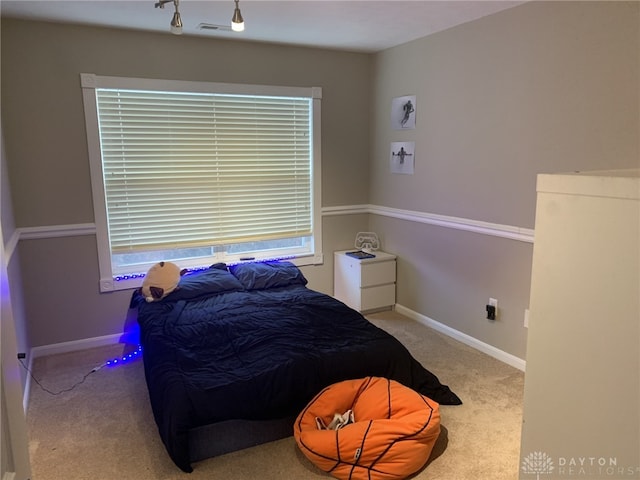 carpeted bedroom featuring visible vents and baseboards