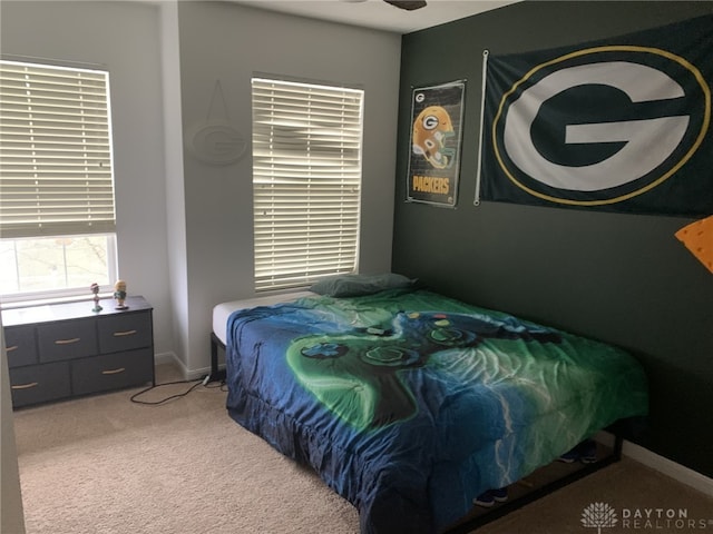 bedroom with light carpet and baseboards