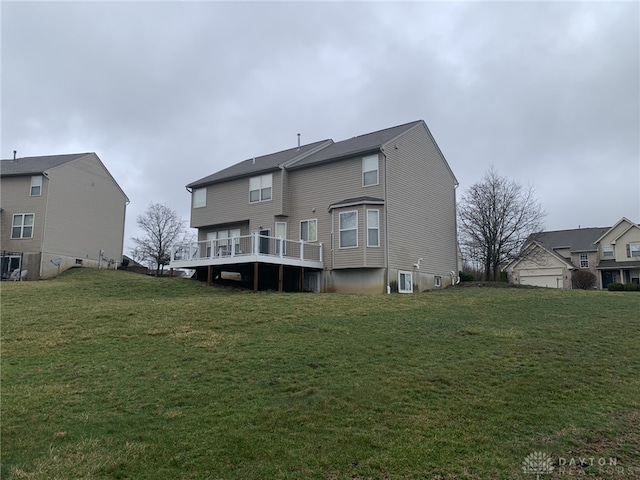 back of property with a yard and a wooden deck