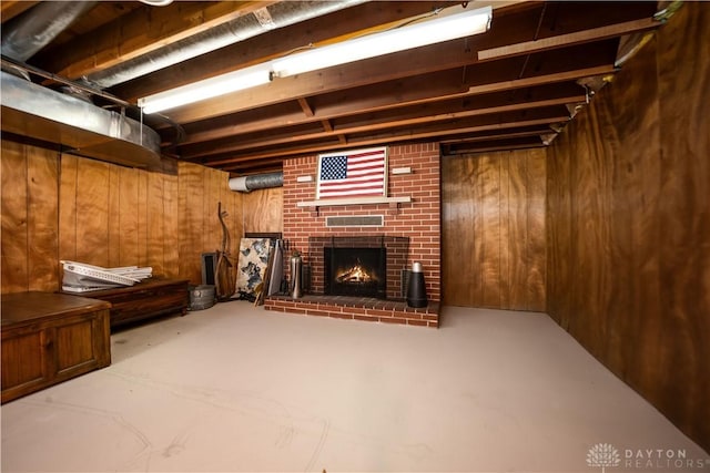 below grade area featuring wooden walls and a fireplace