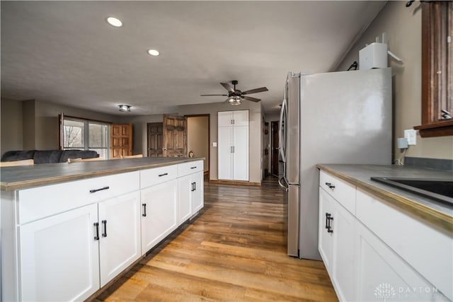 kitchen featuring light wood-type flooring, white cabinetry, recessed lighting, freestanding refrigerator, and ceiling fan