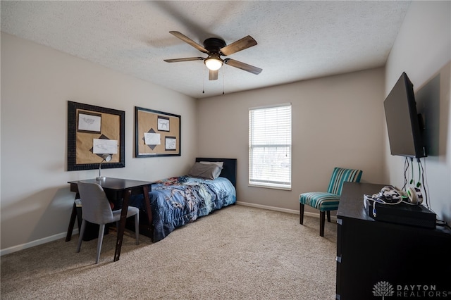 bedroom with baseboards, carpet floors, and a textured ceiling