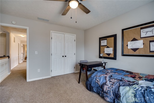 bedroom with visible vents, a textured ceiling, a closet, and carpet flooring