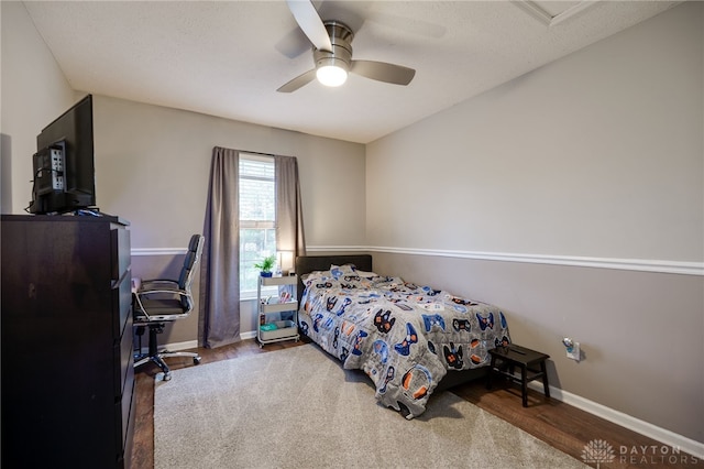 bedroom with wood finished floors, baseboards, and ceiling fan