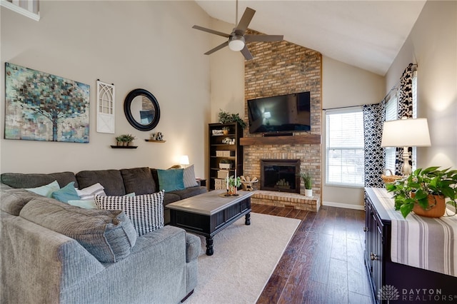 living area featuring a brick fireplace, dark wood-type flooring, baseboards, ceiling fan, and high vaulted ceiling