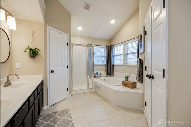 bathroom featuring visible vents, a garden tub, a stall shower, a sink, and double vanity