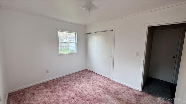 unfurnished bedroom with a closet, baseboards, and carpet