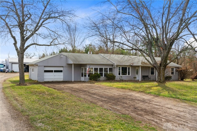 6384 Heffner Rd, Tipp City, OH 45371 - ranch-style house with a garage, dirt driveway, a front yard, and stucco siding