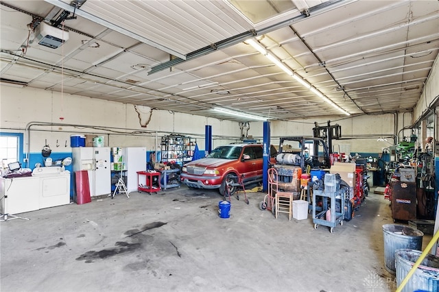 6384 Heffner Rd, Tipp City, OH 45371 - garage featuring a garage door opener and separate washer and dryer